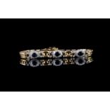 Sapphire and diamond bracelet, 3 sapphires, 4 claw set, each surrounded by 10 diamonds, 6