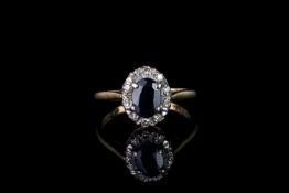 Sapphire and diamond cluster ring, 1 sapphire, 4 claw set, surrounded by 10 diamonds, 18ct yellow