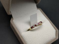 Ruby and diamond half eternity ring, alternating round cut rubies and round brilliant cut