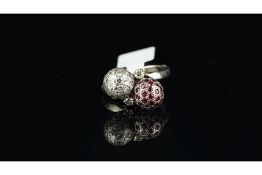 Ruby and diamond crossover ball ring, one set with rubies, the other diamonds, mounted in unmarked