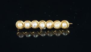A seed pearl bar brooch, seven seed pearls, in a yellow metal bar, stamped 14, a/f, gross weight