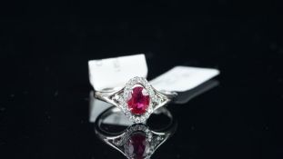 NEW OLD STOCK, Ruby and diamond ring, oval cut ruby estimated weight 0.77ct, diamond set surround,