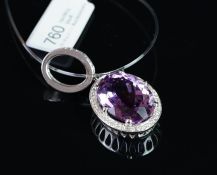 NEW OLD STOCK, UNWORN RETIRED STOCK - An amethyst and diamond pendant, central oval cut amethyst
