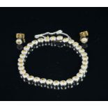 A yellow and white diamond cluster bracelet with matching earrings, thirty-three diamond clusters,