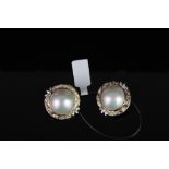 Pair of Mabe pearl clip on earrings, total of 2 Mabe pearls set to the centre measuring