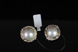 Pair of Mabe pearl clip on earrings, total of 2 Mabe pearls set to the centre measuring