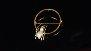 Spider brooch, pearl body, with peridot set eyes, on a yellow metal hoop brooch, approximate