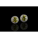 Pair of Diamond cluster earrings, set with 2 fancy intense greenish yellow diamonds totalling 1.34