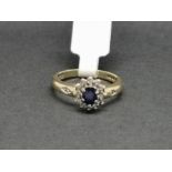 Sapphire and diamond cluster ring, oval cut sapphire surrounded by single cut diamonds, in 9ct