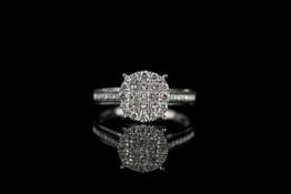 Diamond cluster ring, 9 princess cut diamonds to the centre, surrounded by 16 round brilliant cut