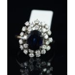 Sapphire and diamond dress ring, central oval cut sapphire measuring approximately 9.29 x 7.63 x 3.