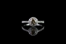 Cognac diamond cluster ring, set with 1 light brown round brilliant cut diamond totalling 0.74ct,
