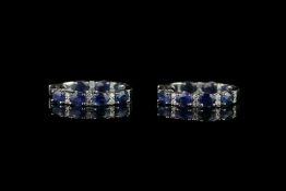 Pair of Sapphire and Diamond hoop earrings, set with 14 oval cut sapphires totalling 5.74 ct, 4 claw