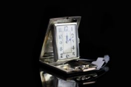 ANTIQUE ESZEHA TRAVEL POCKET CLOCK, rectangular off white patina dial with unusual black arabic