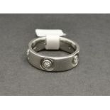 A diamond set wedding band, five round brilliant cut diamonds weighing an estimated 0.30ct, set in a