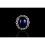 Cabochon sapphire and diamond ring, central cabochon blue sapphire, approximately 13.6x11.4x6.9mm,