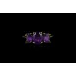 3 stone amethyst ring, centre amethyst stone measuring approximately 8.02mm x 6.11mm, set with 2