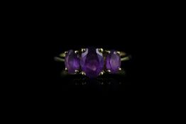 3 stone amethyst ring, centre amethyst stone measuring approximately 8.02mm x 6.11mm, set with 2