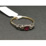 Three stone ruby and diamond ring, mounted in yellow and white metal stamped '18CT PLAT', central