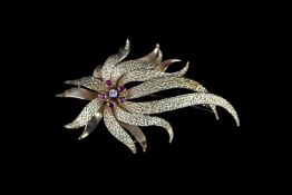 18CT FIRE BROOCH SET WITH CENTRAL DIAMOND AND FOUR RUBIES.diamond estimated at 0.06ct, rubies