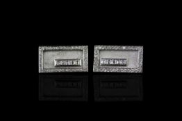 Diamond set cufflinks, rectangular panels with a border of brilliant cut diamonds, five trap cut