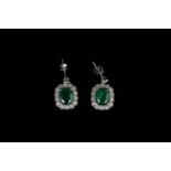 Pair of Emerald and Diamond earrings, set with 2 oval cut diamonds totalling 4.41ct, 4 claw set,