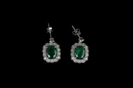 Pair of Emerald and Diamond earrings, set with 2 oval cut diamonds totalling 4.41ct, 4 claw set,