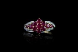 Ruby and Diamond cluster ring, set with 11 rubies in a flower shape, 6 diamonds set to the