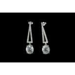 Pair of Aquamarine and Diamond earrings, set with 2 oval cut light blue aquamarines totalling 8.9ct,