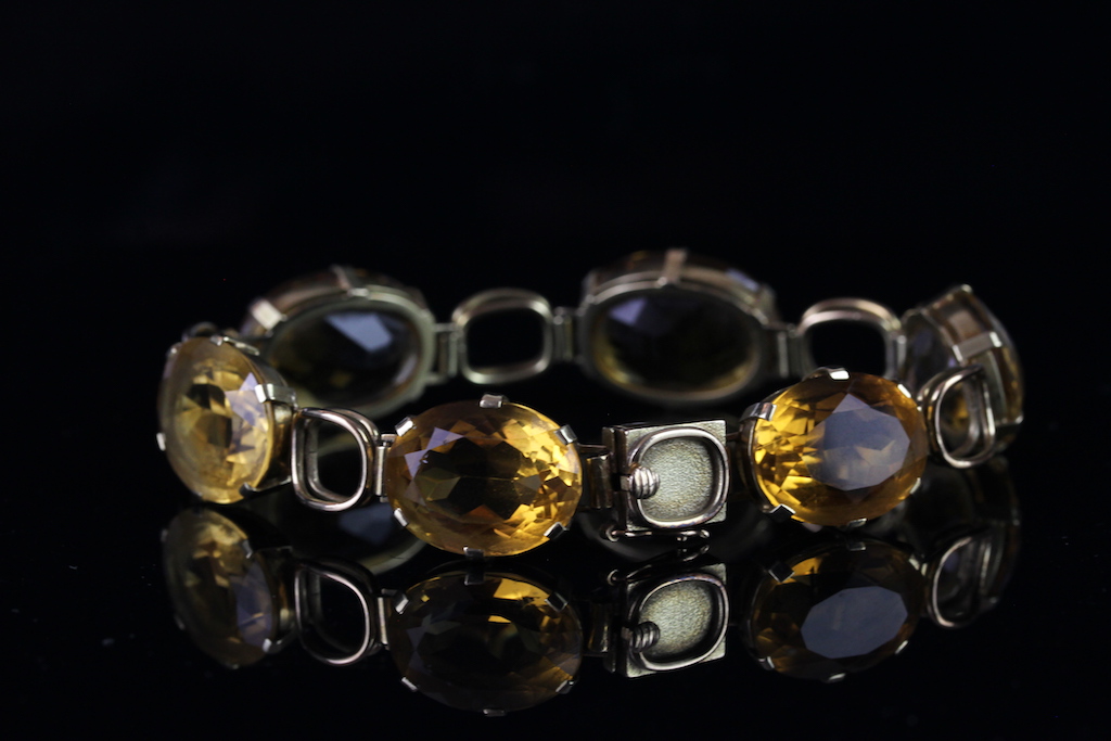 Citrine bracelet, mounted in yellow metal, set with six oval citrines, with tongue and box clasp,