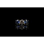 3 stone diamond & sapphire ring, round brilliant cut diamond set to the centre approximately 0.60ct,