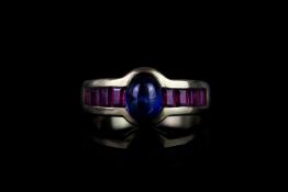 Sapphire & ruby ring, cabochon cut sapphire set to the centre measuring approximately 7.9mm x 5.9mm,