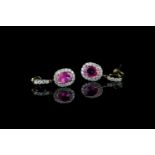 Pair of Pink Sapphire and Diamond earrings, set with 2 oval cut pink sapphires totalling 1.64ct,