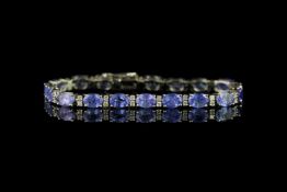 Tanzanite and Diamond bracelet, set with 19 oval cut tanzanites totalling 15.10ct, surrounded by