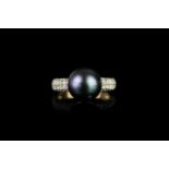 Tahitian Pearl and Diamond ring, set with 1 round tahitian pearl measuring approximately 10.43mm, 56