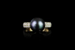 Tahitian Pearl and Diamond ring, set with 1 round tahitian pearl measuring approximately 10.43mm, 56