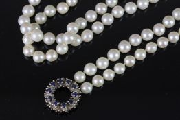 Single row white pearl necklet, on white metal blue stone set clasp stamped 585, approximate