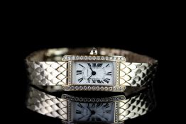 STUNNING LADIES 18K ROSE GOLD DIAMOND SET CARTIER WRISTWATCH,diamond set case, oblong, textured dial