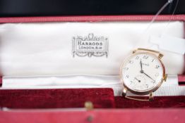 GENTLEMEN'S HARRODS 9CT GOLD DRESS WATCH W/ BOX, circular off white dial with black fancy arabic