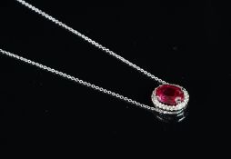 A synthetic ruby and diamond cluster pendant, central oval cut synthetic ruby, surrounded by round