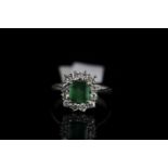 18CT WHITE GOLD EMERALD AND DIAMOND CLUSTER RING,emerald estimated 6.3x 6.4mm, hallmarked , ring
