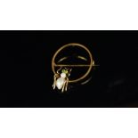 Spider brooch, pearl body, with peridot set eyes, on a yellow metal hoop brooch, approximate