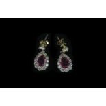 18K RUBY AND DIAMOND DROP EARRINGS,rubies estimated 6.03 x 7.10 mm,graduated diamond surround.