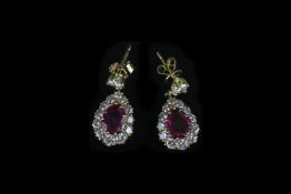 18K RUBY AND DIAMOND DROP EARRINGS,rubies estimated 6.03 x 7.10 mm,graduated diamond surround.