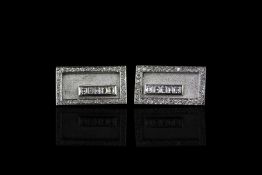 Diamond set cufflinks, rectangular panels with a border of brilliant cut diamonds, five trap cut