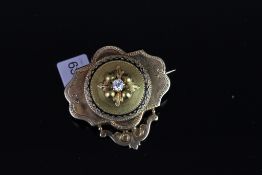 Victorian diamond and enamel brooch, single diamond to centre, leaf detail, outer ring with black