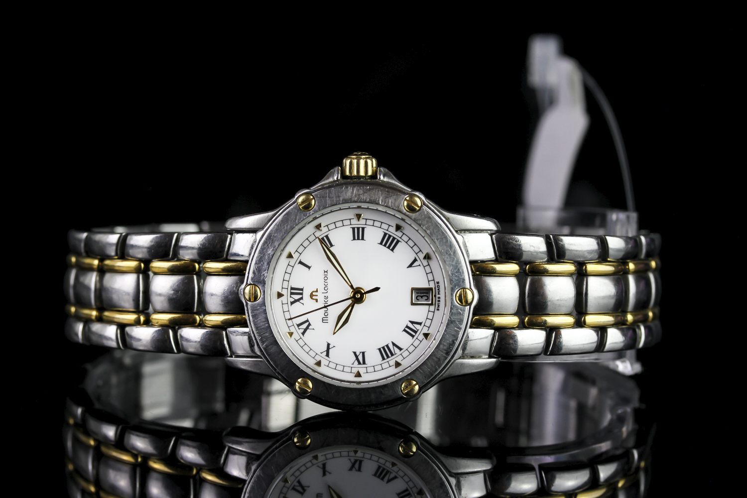 LADIES MAURICE LACROIX 13917,round,white dial with illuminated hands, black roman numeral markers,