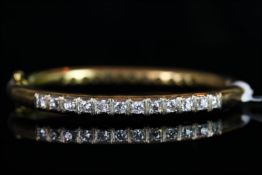 18CT DOUBLE SIDED DIAMOND BANGLE, set with 12 stones either side, estimated total weight 2.6ct,