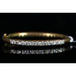 18CT DOUBLE SIDED DIAMOND BANGLE, set with 12 stones either side, estimated total weight 2.6ct,