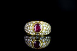 Ruby and Diamond cluster ring, set with 1 oval cut ruby, rubover set, surrounded by round